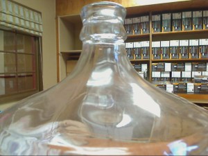 Glass carboy.  The neck goes up wards making it so brew has less surface area to get oxidized. 